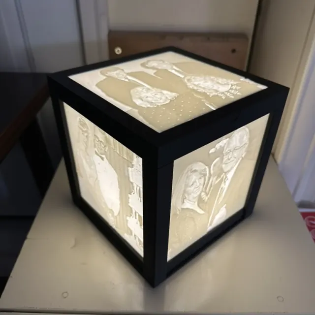A finished illuminated Anam Light with photographs on its panels